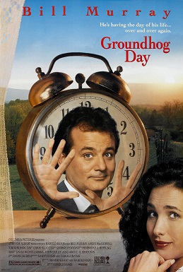 The poster for the movie Groundhog Day featuring Bill Murray stuck in a clock on a windowsill as Andie MacDowell looks on.